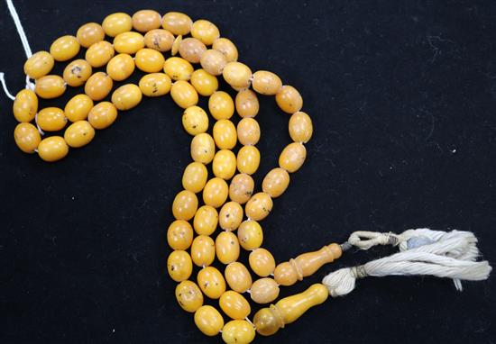 Two single strand amber bead necklaces,